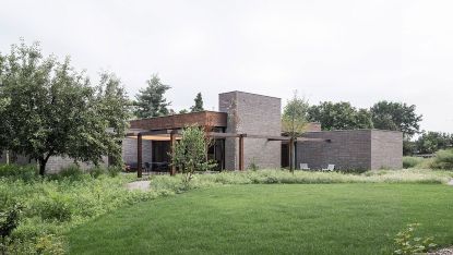 belgian brick bungalow exterior among nature